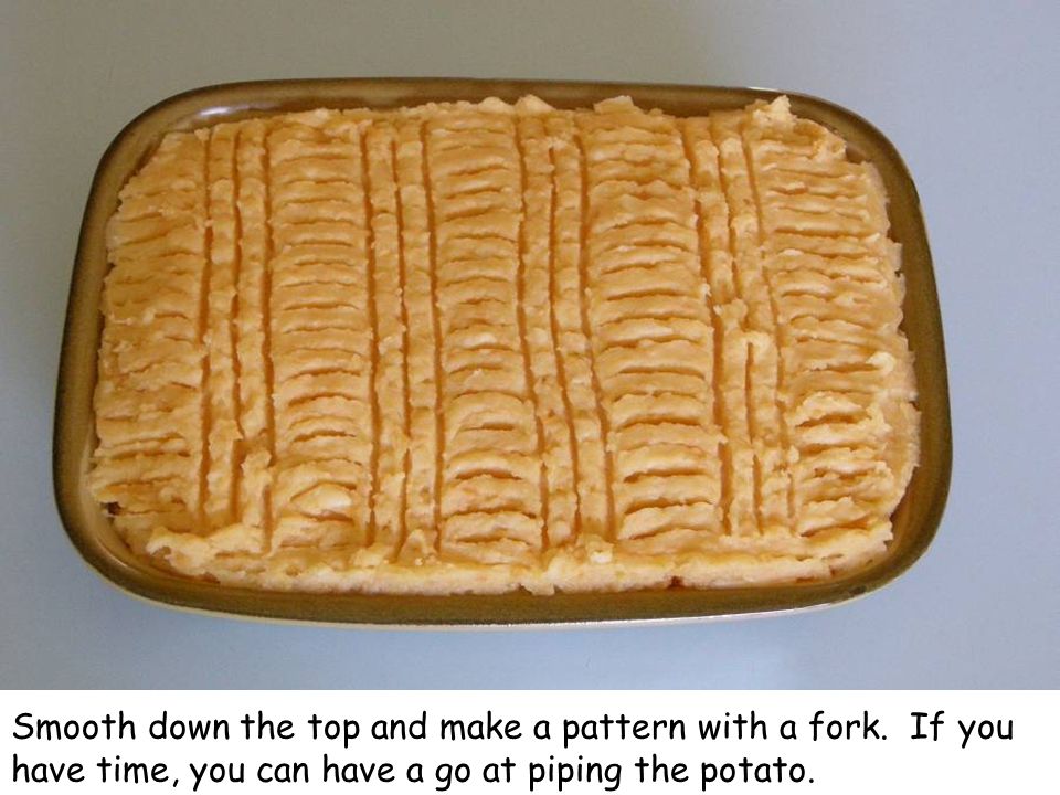 Smooth down the top and make a pattern with a fork.