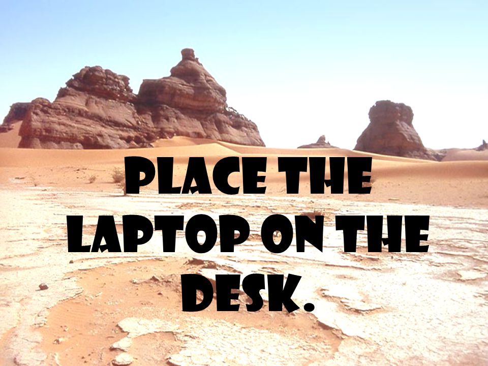 Place the laptop on the desk.