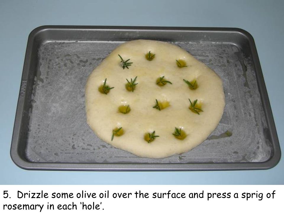 5. Drizzle some olive oil over the surface and press a sprig of rosemary in each ‘hole’.