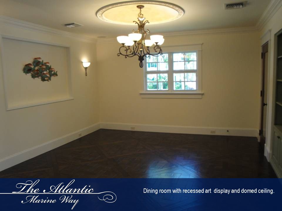 Dining room with recessed art display and domed ceiling.
