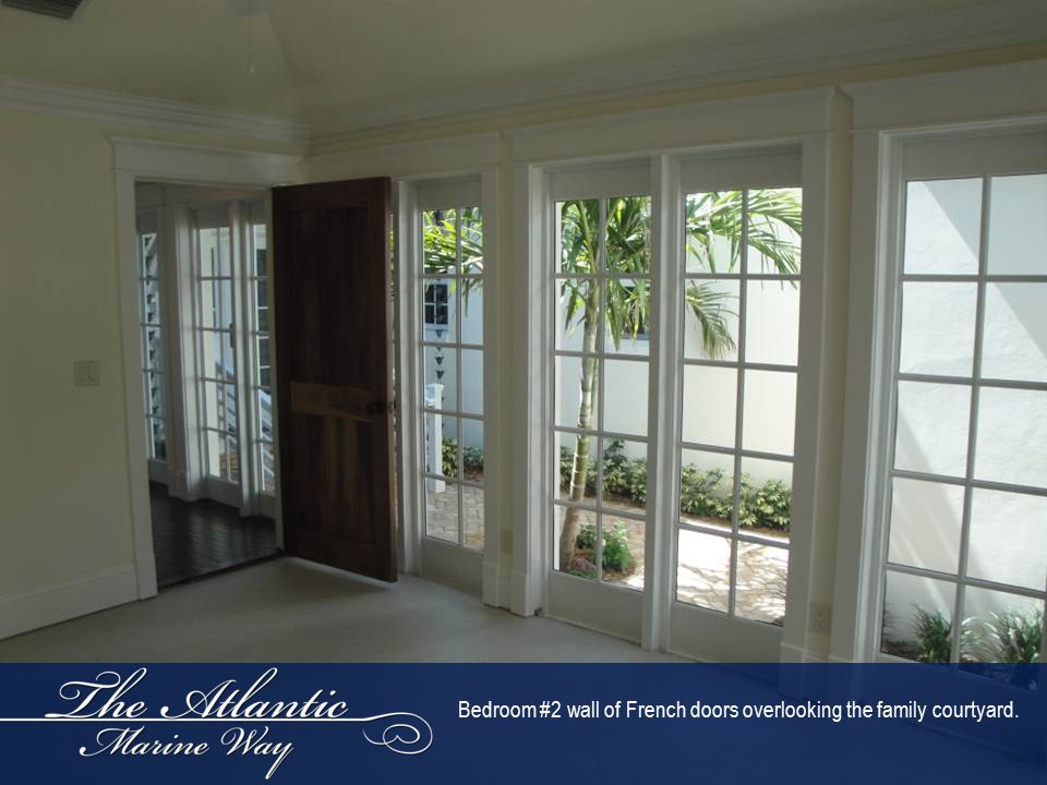 Bedroom #2 wall of French doors overlooking the family courtyard.