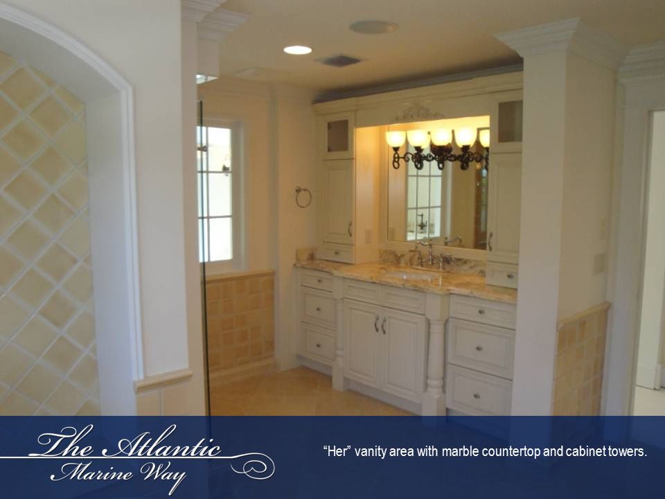 Her vanity area with marble countertop and cabinet towers.