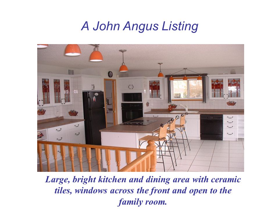 A John Angus Listing Large, bright kitchen and dining area with ceramic tiles, windows across the front and open to the family room.
