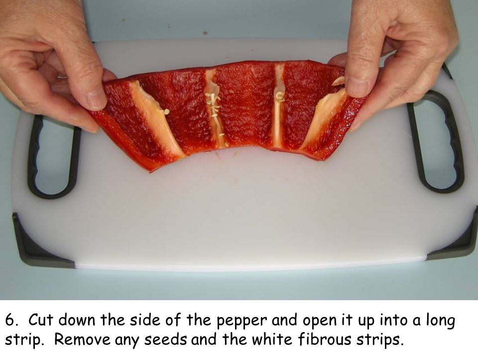 6. Cut down the side of the pepper and open it up into a long strip.