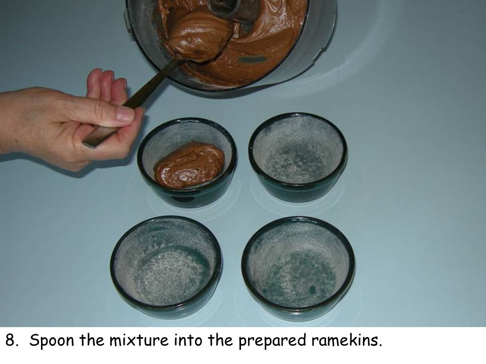 8. Spoon the mixture into the prepared ramekins.