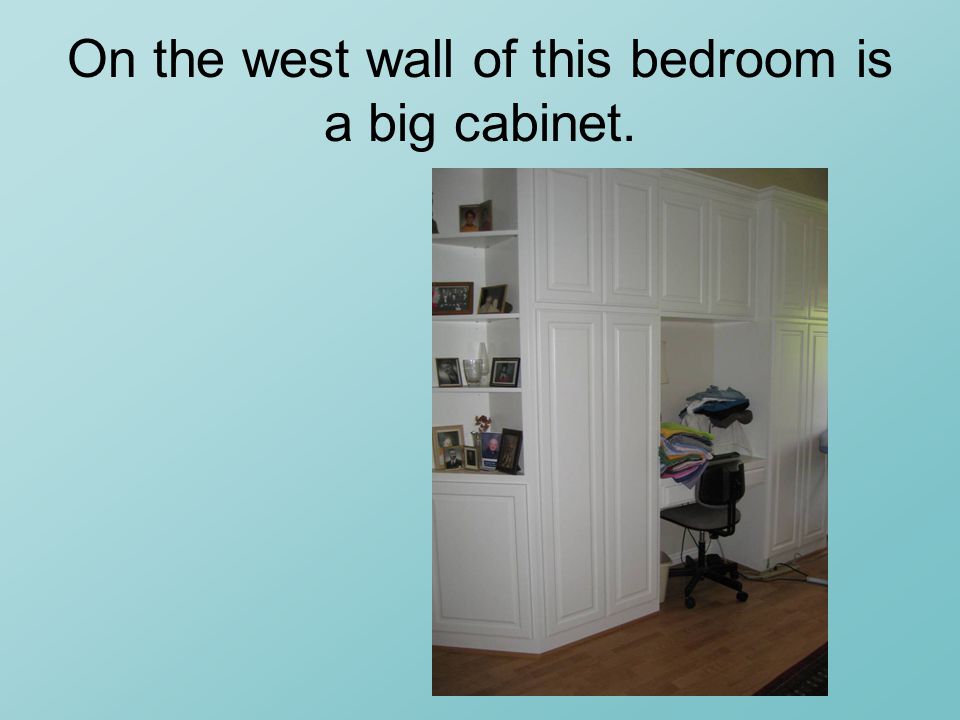 On the west wall of this bedroom is a big cabinet.