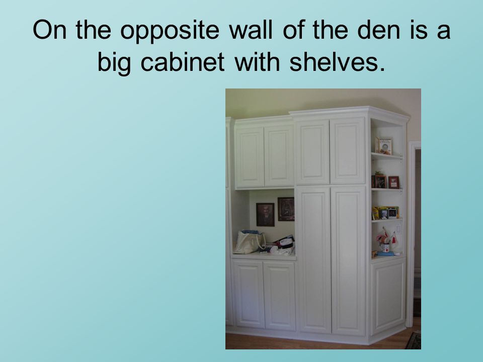 On the opposite wall of the den is a big cabinet with shelves.