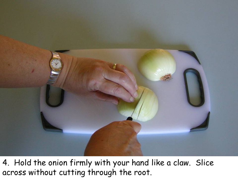 4. Hold the onion firmly with your hand like a claw. Slice across without cutting through the root.