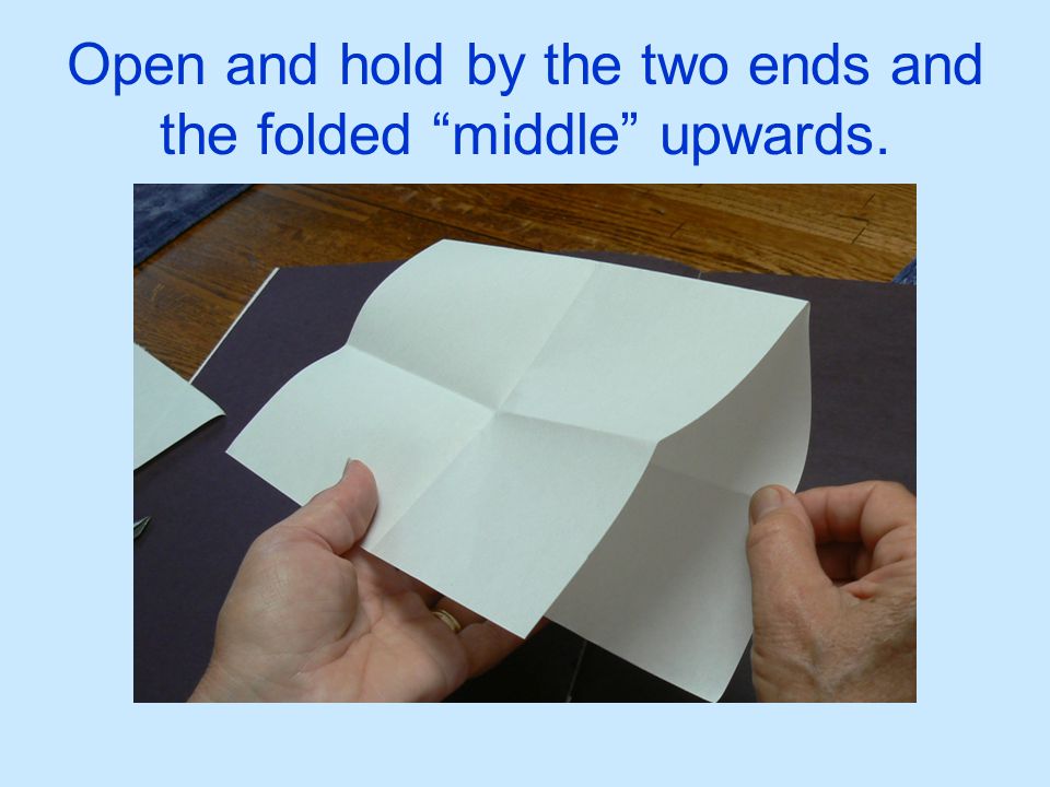 Open and hold by the two ends and the folded middle upwards.