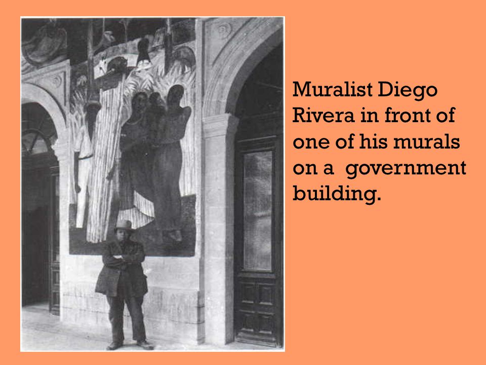 Muralist Diego Rivera in front of one of his murals on a government building.