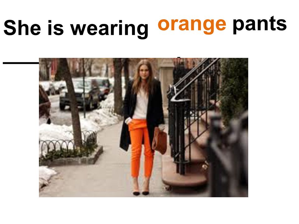 She is wearing _______________. orange pants