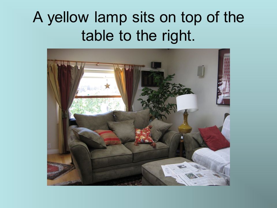 A yellow lamp sits on top of the table to the right.