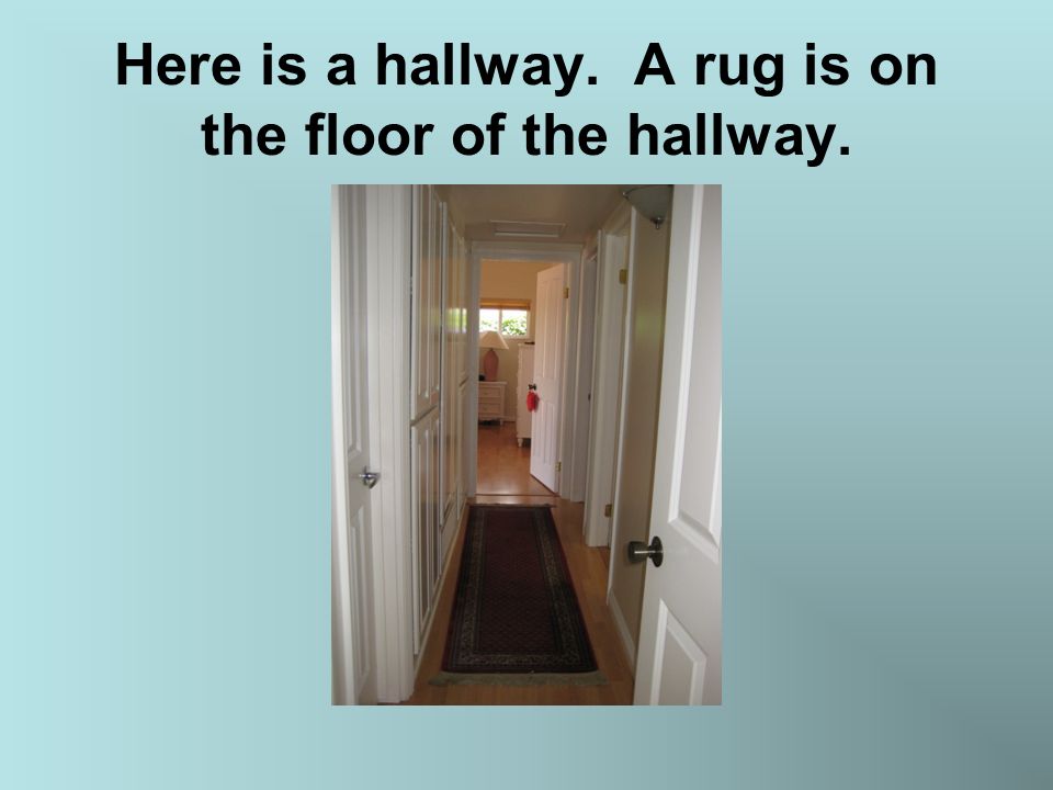 Here is a hallway. A rug is on the floor of the hallway.