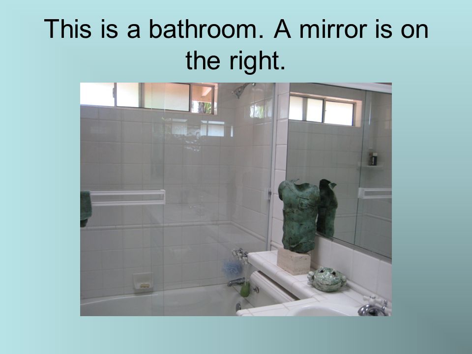 This is a bathroom. A mirror is on the right.