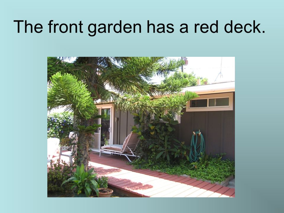 The front garden has a red deck.