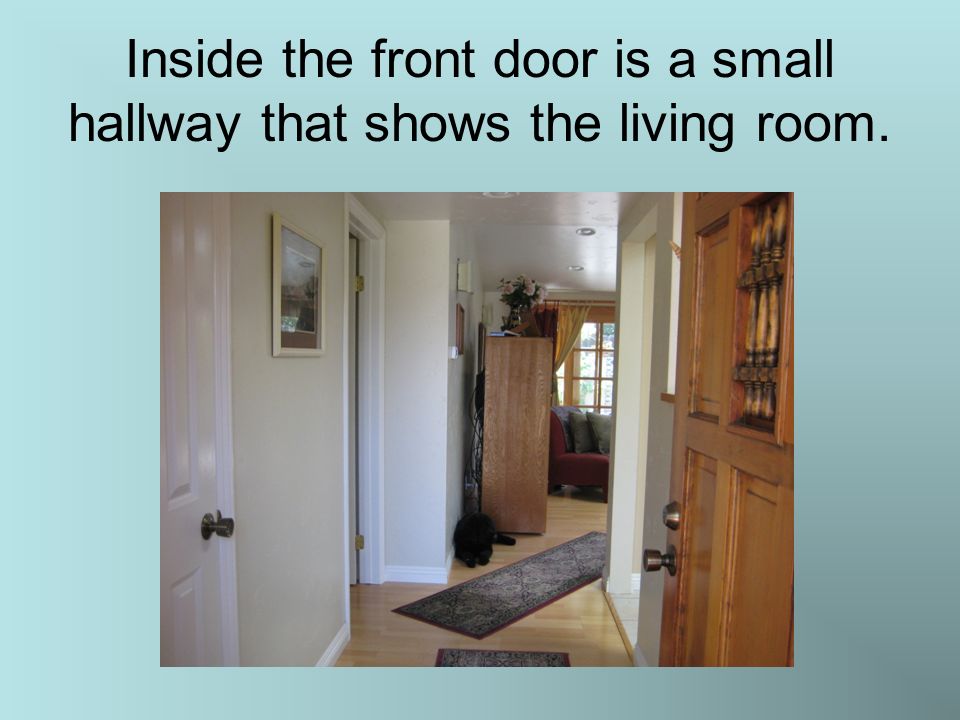 Inside the front door is a small hallway that shows the living room.