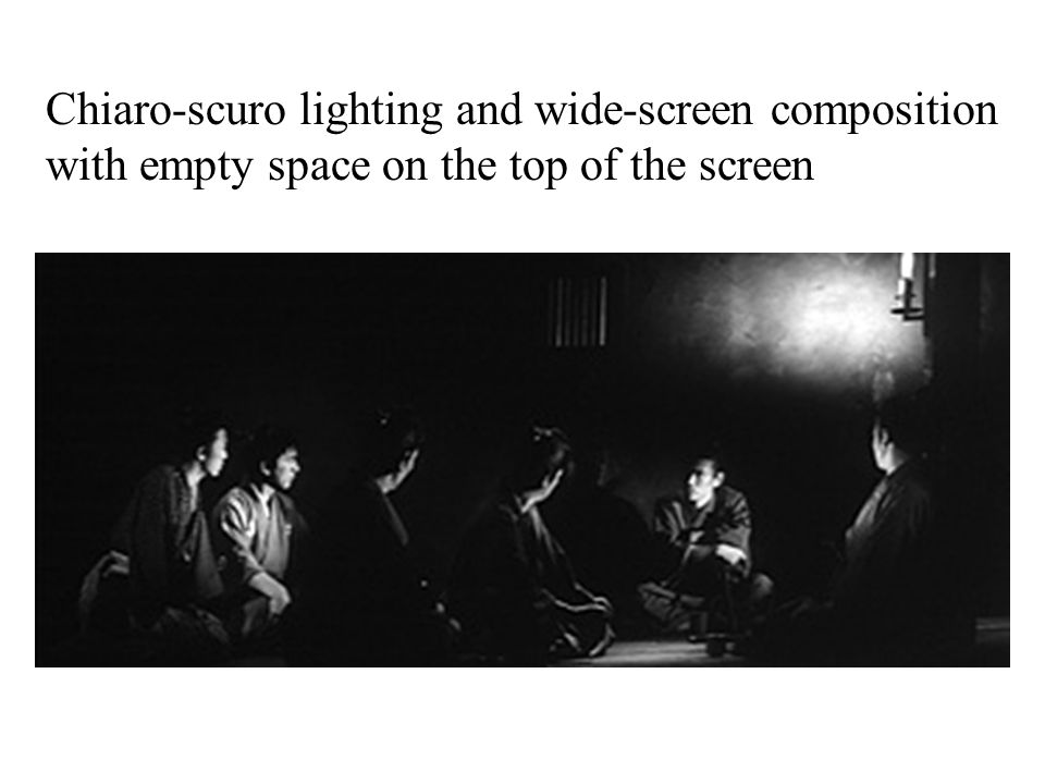 Chiaro-scuro lighting and wide-screen composition with empty space on the top of the screen