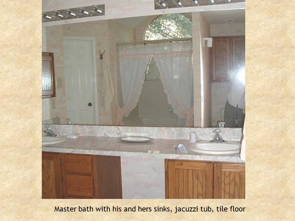 Master bath with his and hers sinks, jacuzzi tub, tile floor