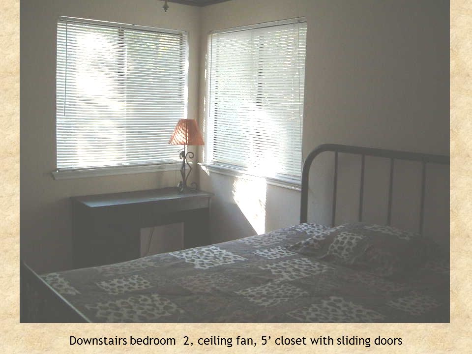 Downstairs bedroom 2, ceiling fan, 5’ closet with sliding doors