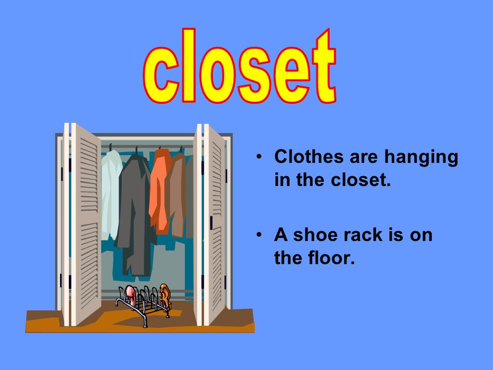 Clothes are hanging in the closet. A shoe rack is on the floor.