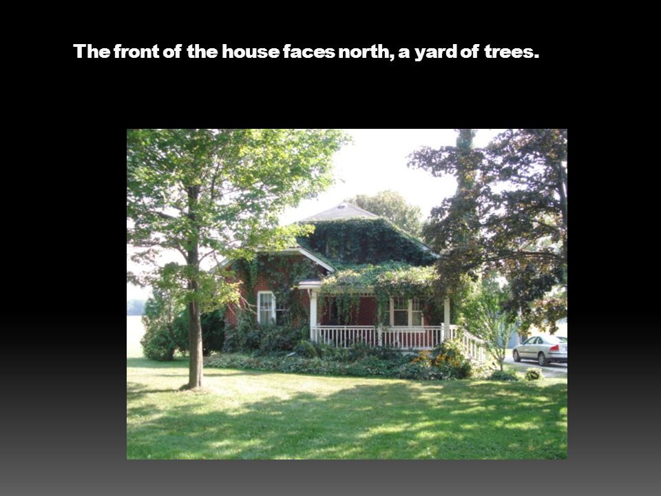 The front of the house faces north, a yard of trees.