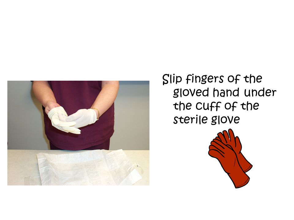 Slip fingers of the gloved hand under the cuff of the sterile glove
