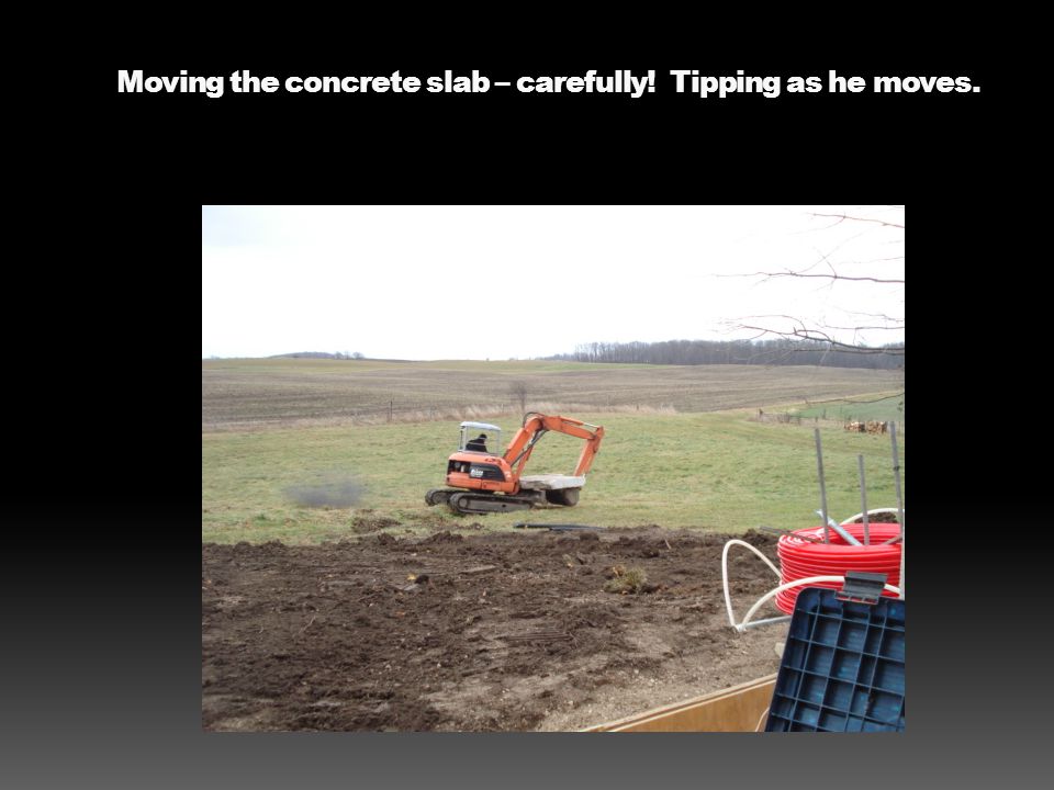 Moving the concrete slab – carefully! Tipping as he moves.