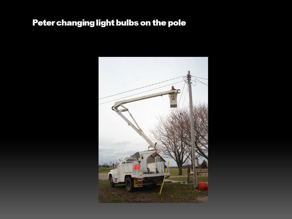 Peter changing light bulbs on the pole