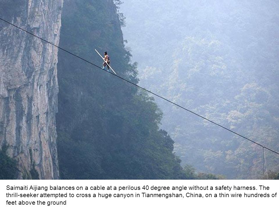 Saimaiti Aijiang balances on a cable at a perilous 40 degree angle without a safety harness.