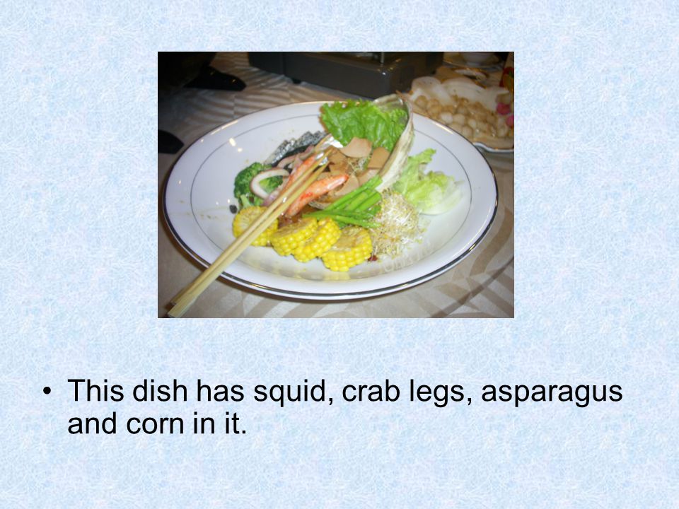 This dish has squid, crab legs, asparagus and corn in it.
