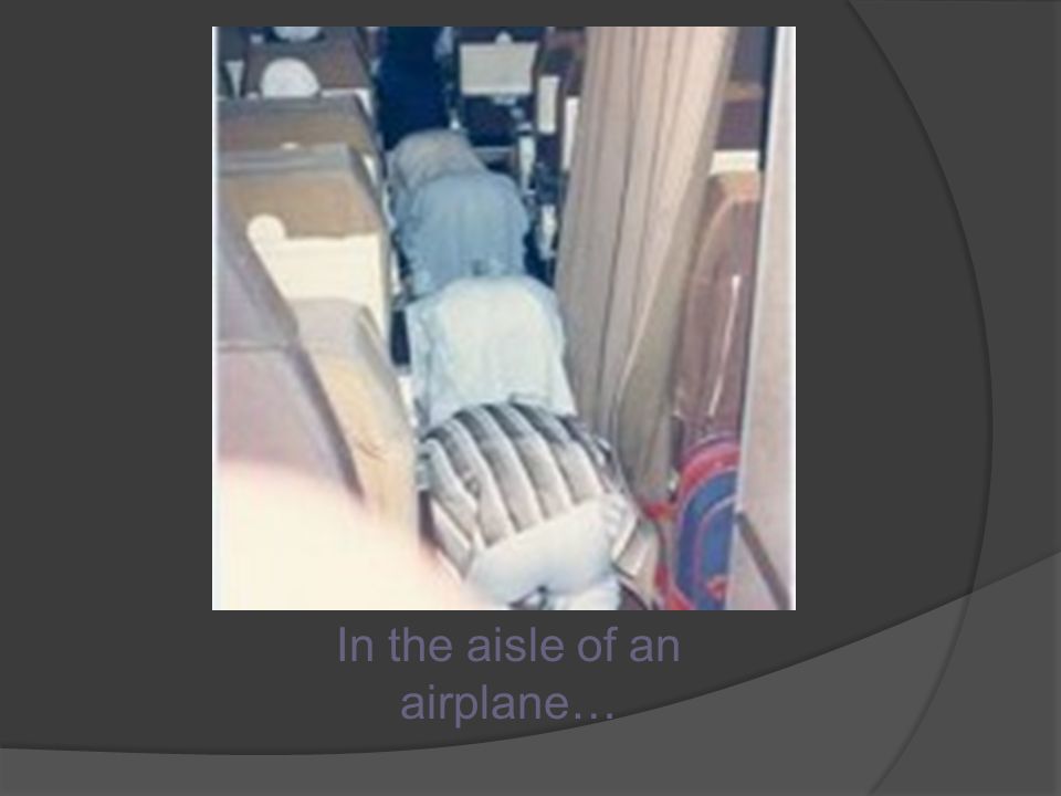 In the aisle of an airplane…