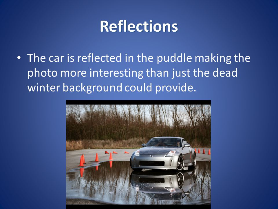Reflections The car is reflected in the puddle making the photo more interesting than just the dead winter background could provide.