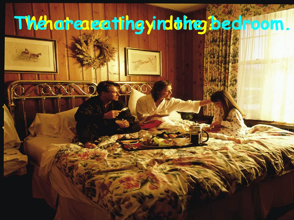 What are they doing The are eating in the bedroom.