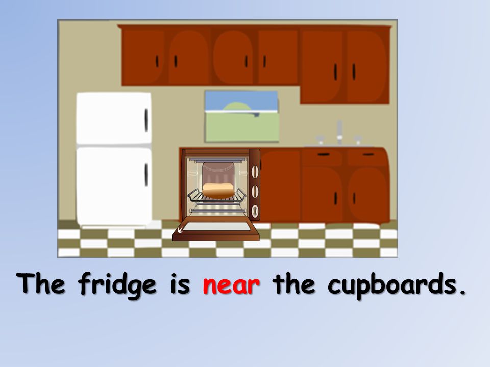 The fridge is near the cupboards.