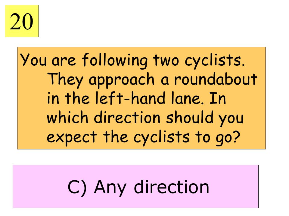 You are following two cyclists. They approach a roundabout in the left-hand lane.
