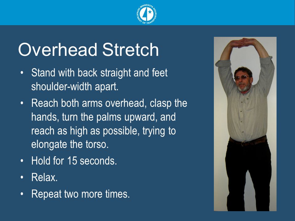 Overhead Stretch Stand with back straight and feet shoulder-width apart.