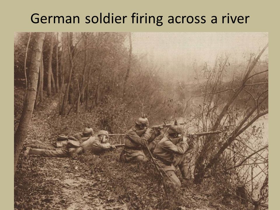 German soldier firing across a river