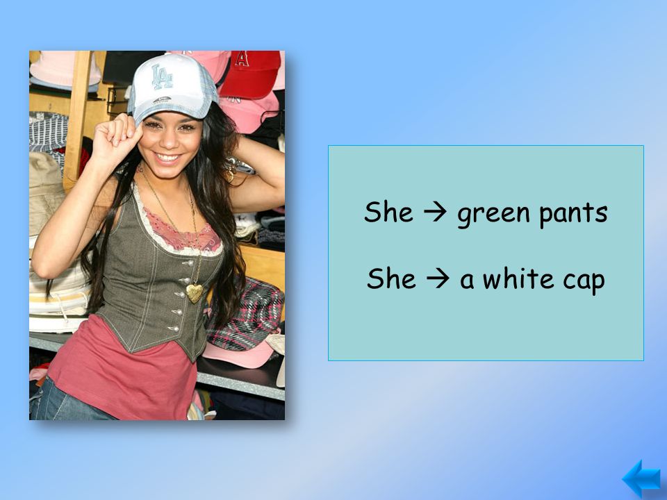She doesn’t have green pants. She has a white cap. She  green pants She  a white cap