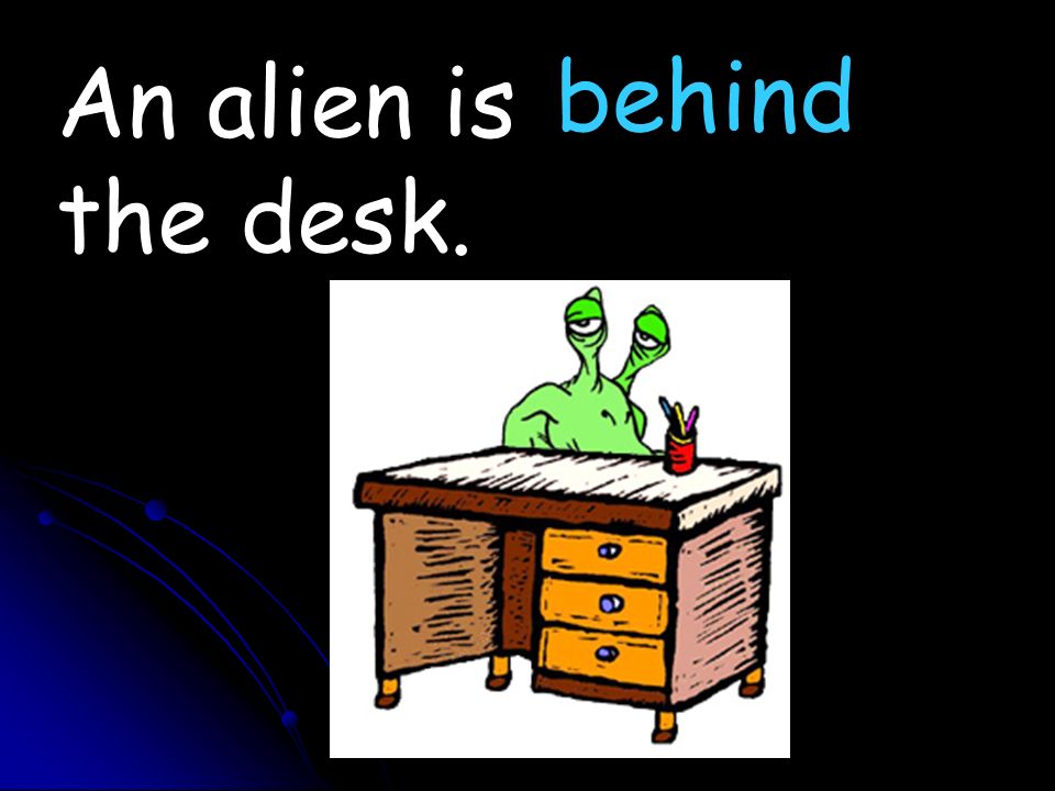 An alien is the desk. behind