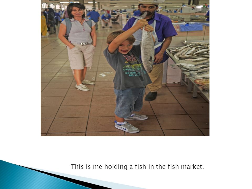 This is me holding a fish in the fish market.