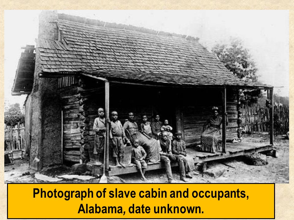 Photograph of slave cabin and occupants, Alabama, date unknown.