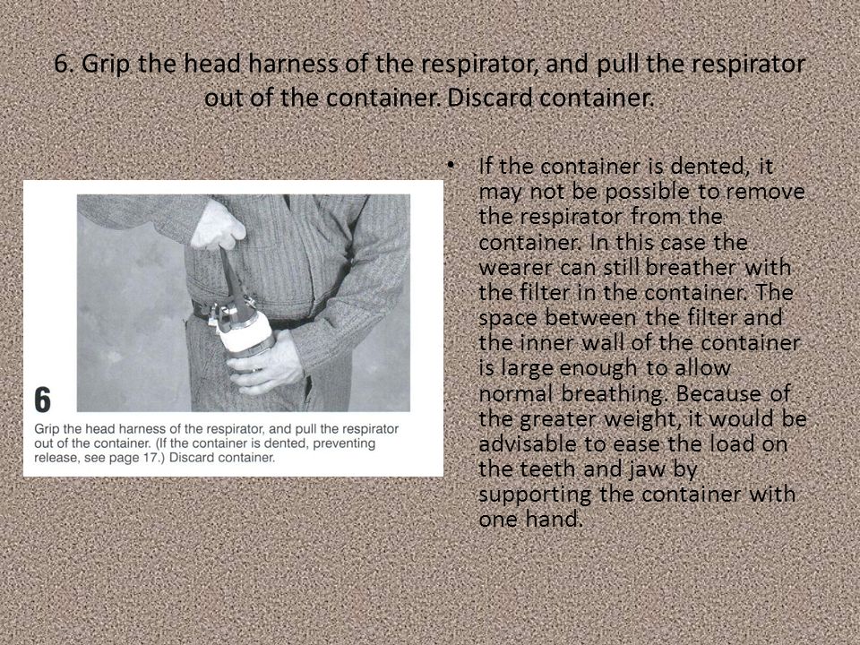 6. Grip the head harness of the respirator, and pull the respirator out of the container.