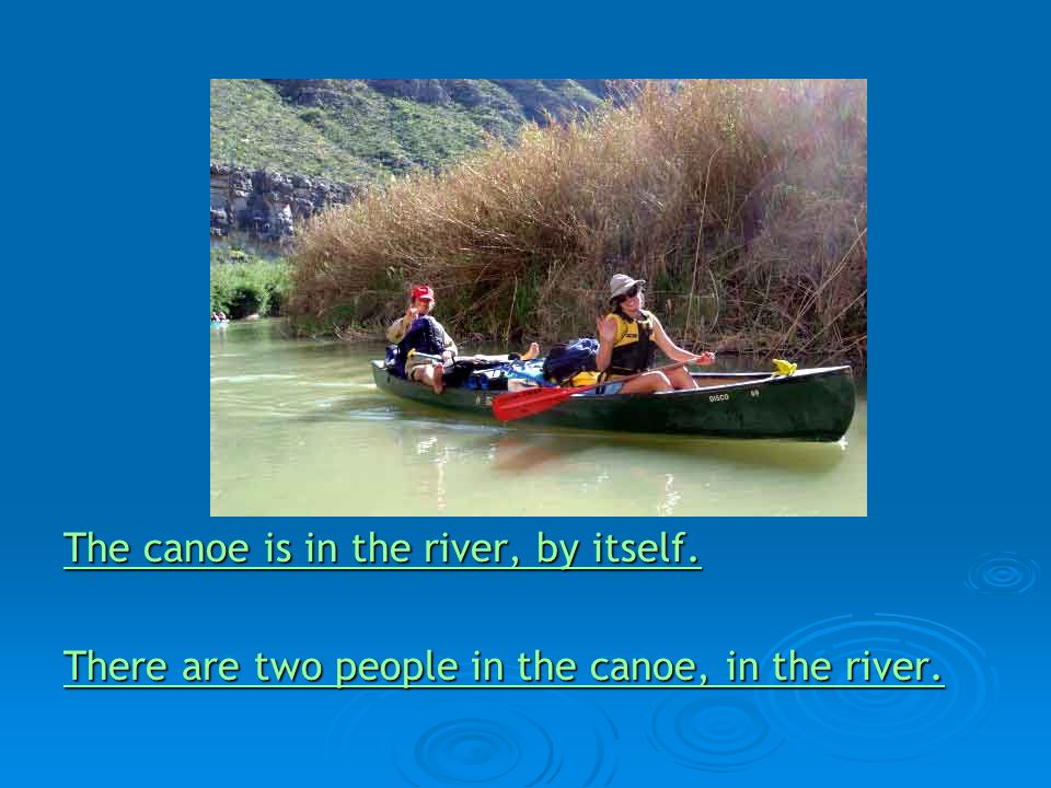 The canoe is in the river, by itself. The canoe is in the river, by itself.