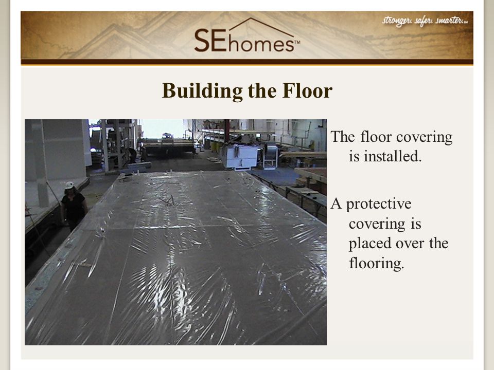 The floor covering is installed. A protective covering is placed over the flooring.